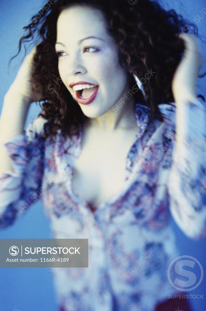 Stock Photo: 1166R-4189 Young woman holding her hair smiling