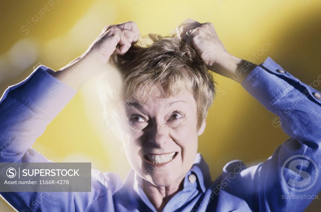 Stock Photo: 1166R-4278 Senior woman pulling her hair
