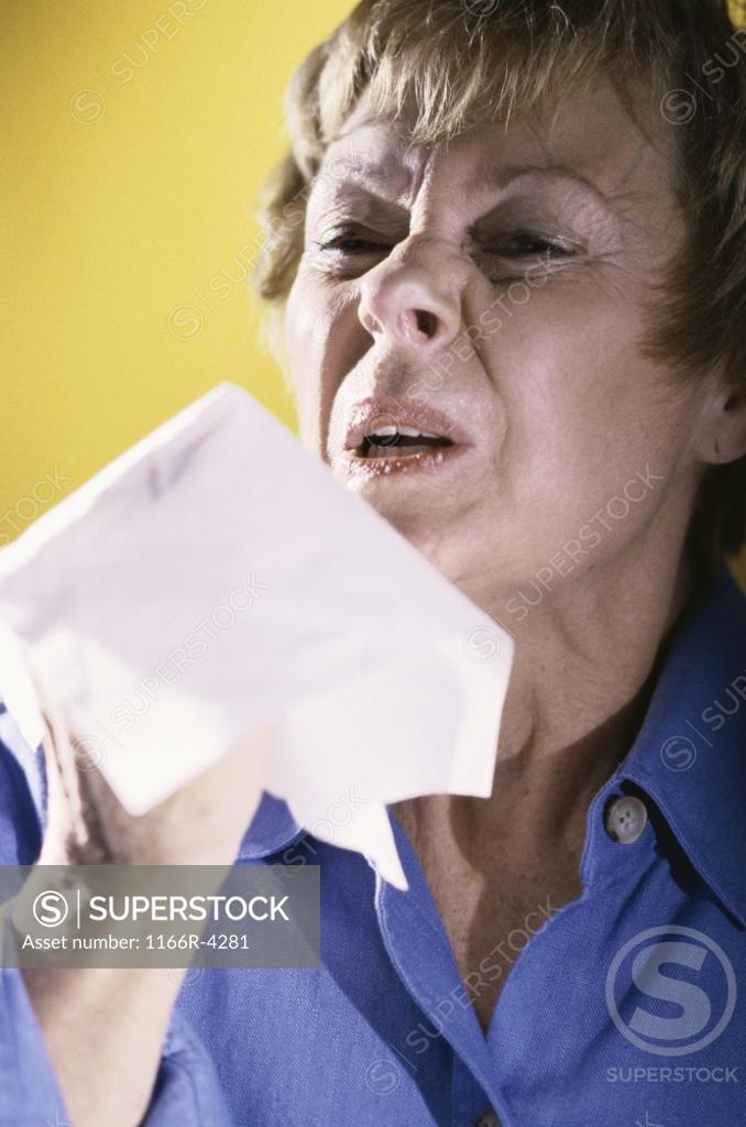 Stock Photo: 1166R-4281 Woman sneezing into a handkerchief