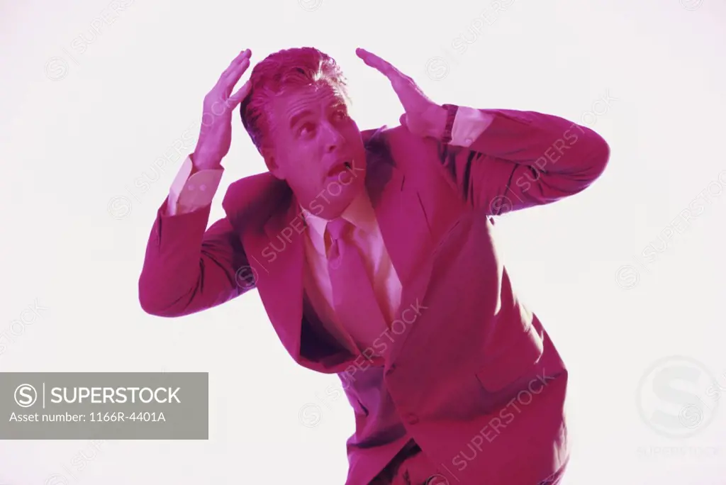 Businessman with his hands over his head