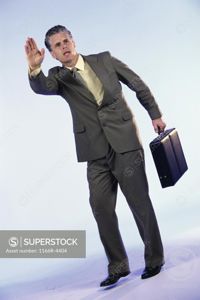 Stock Photo: 1166R-4404 Businessman standing holding a briefcase