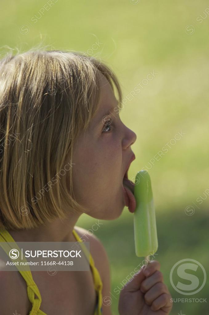 Stock Photo: 1166R-4413B Side profile of a girl holding an ice cream
