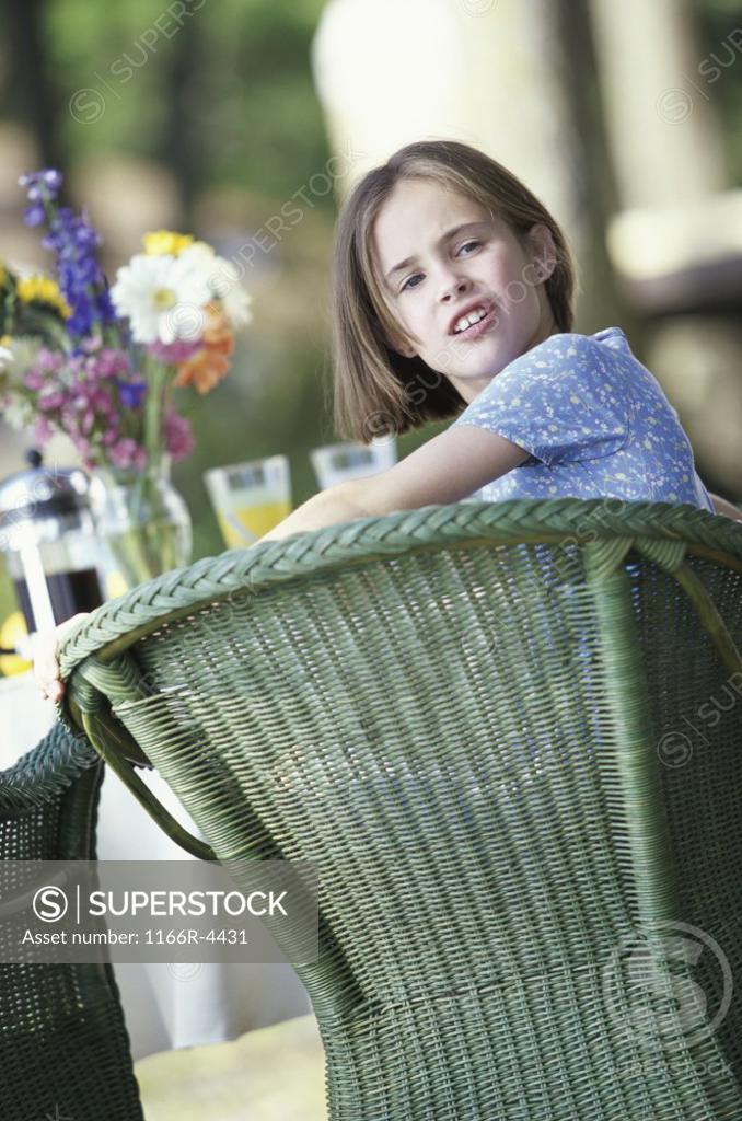 Stock Photo: 1166R-4431 Portrait of a girl sitting at a table