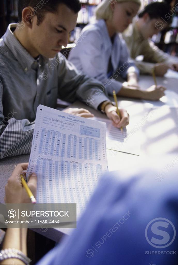 Stock Photo: 1166R-4464 Students writing during an examination