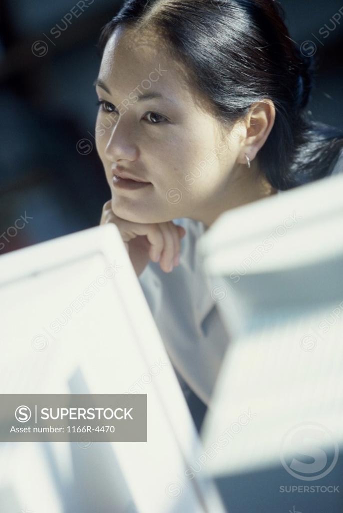 Stock Photo: 1166R-4470 Young woman looking at a computer monitor
