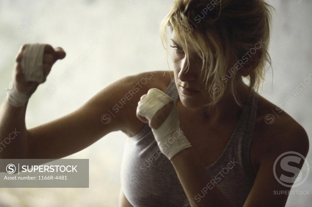 Stock Photo: 1166R-4481 Female boxer practicing