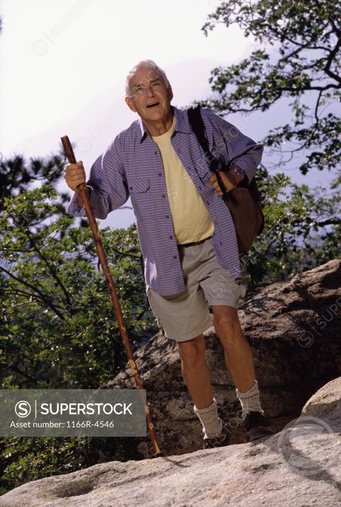 Stock Photo: 1166R-4546 Portrait of a senior man holding a hiking pole