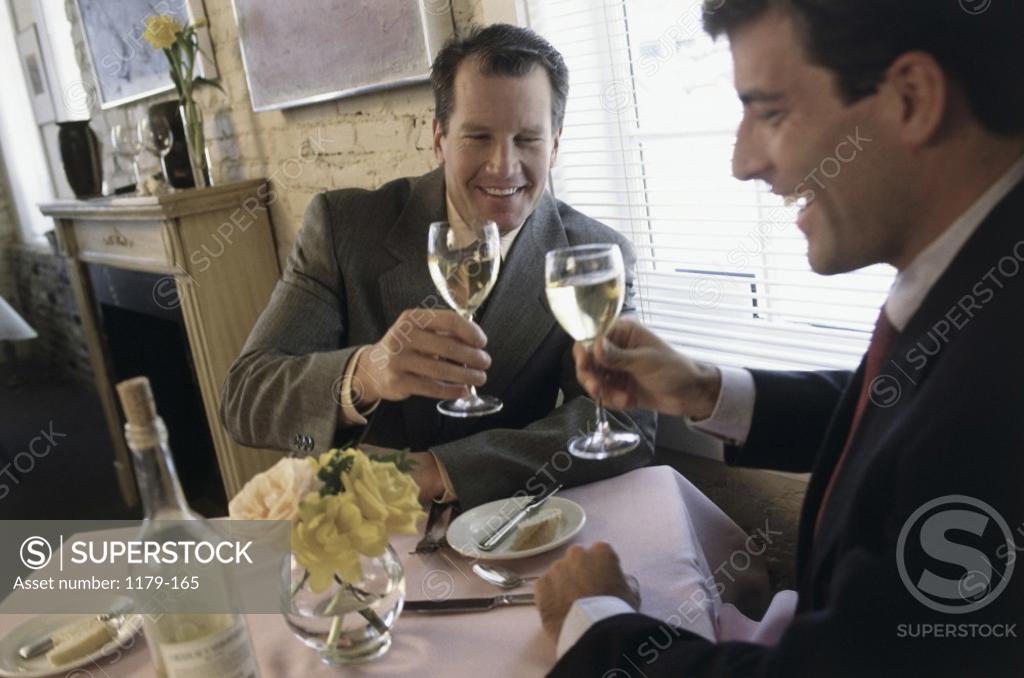Stock Photo: 1179-165 Two businessmen toasting with white wine