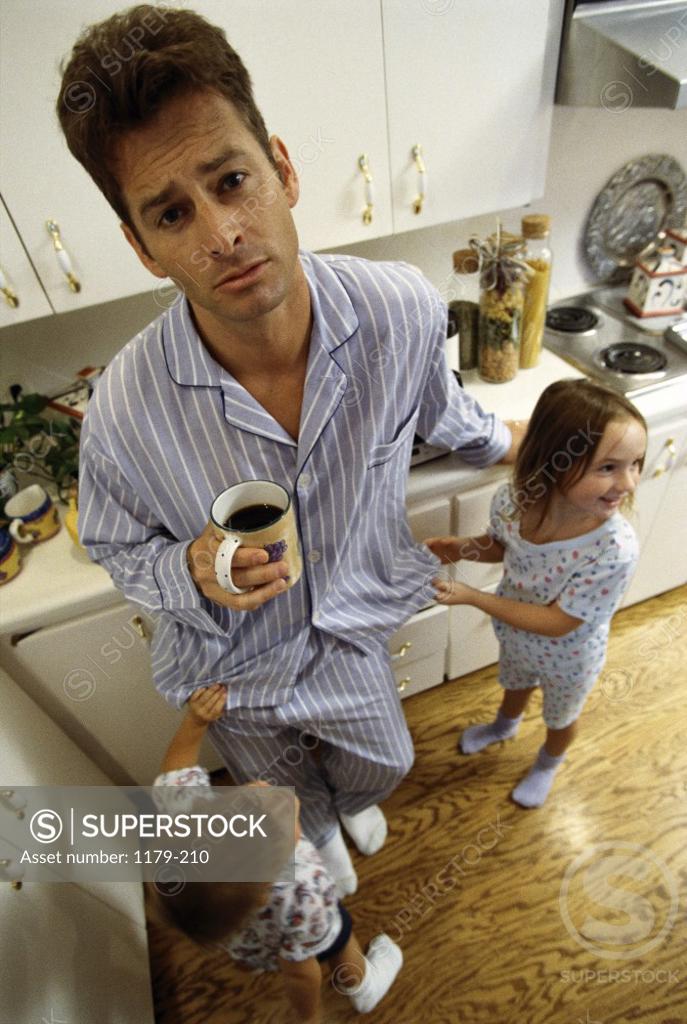 Stock Photo: 1179-210 Father with his son and daughter in the kitchen