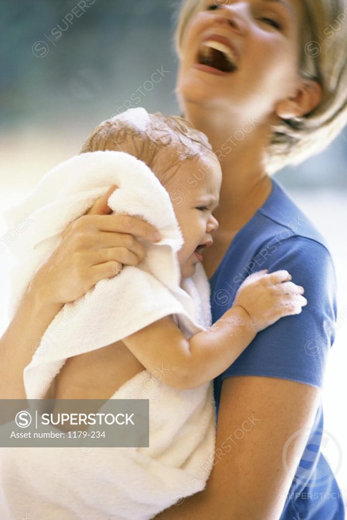 Stock Photo: 1179-234 Side profile of a mother carrying her baby boy