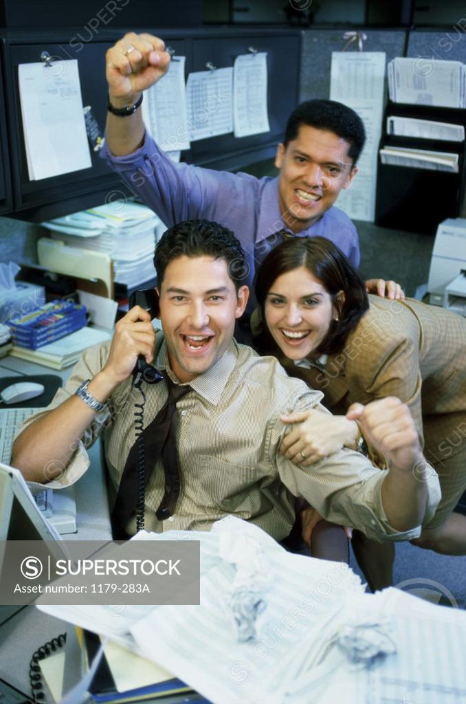 Stock Photo: 1179-283A Two businessmen and a businesswoman in an office