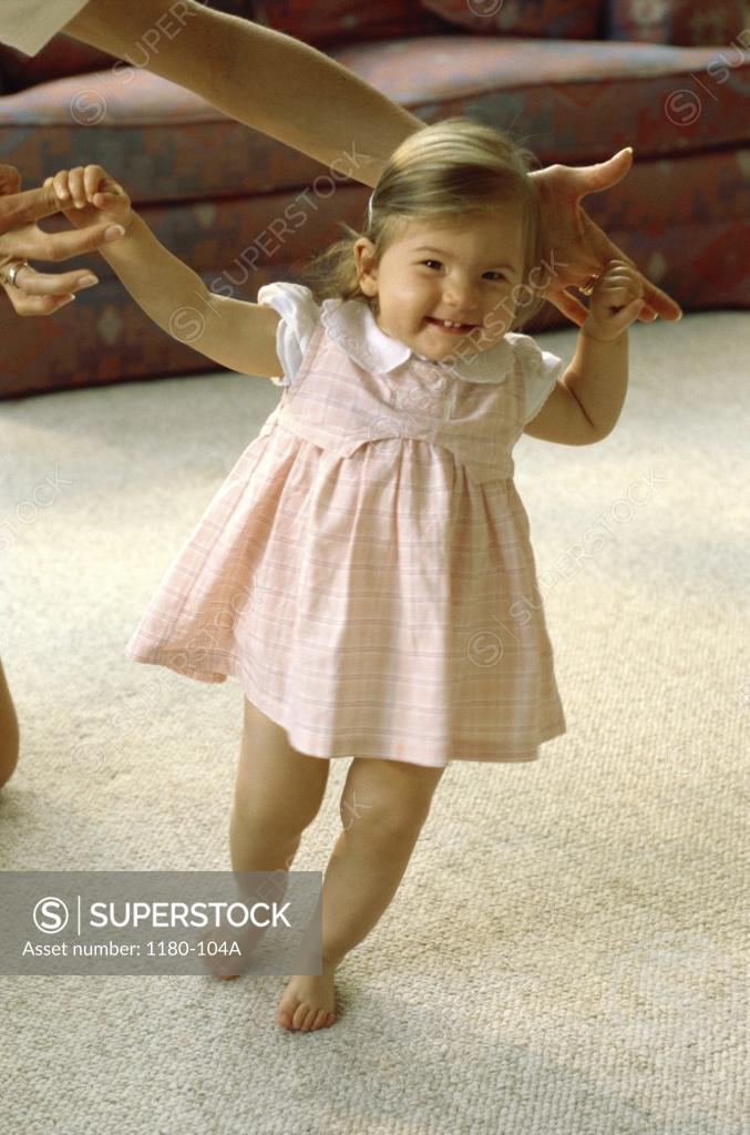 Stock Photo: 1180-104A Mother helping her baby girl walk