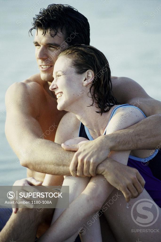 Stock Photo: 1180-108A Mid adult couple holding each other on the beach