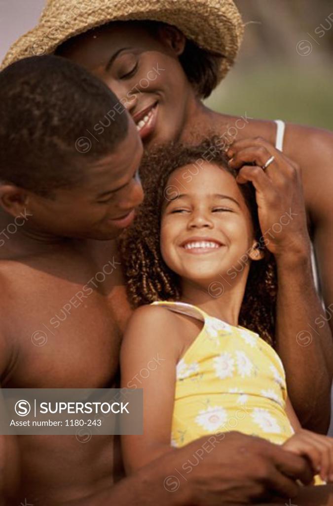 Stock Photo: 1180-243 Young couple standing together smiling with their daughter