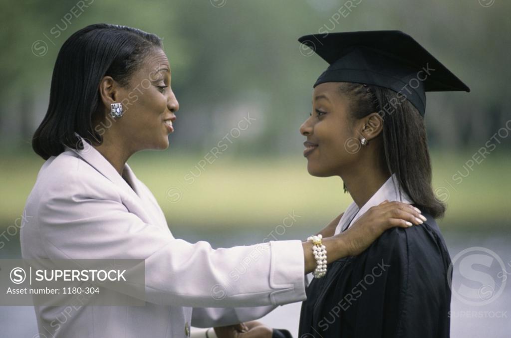 Stock Photo: 1180-304 Side profile of a young female graduate with her mother