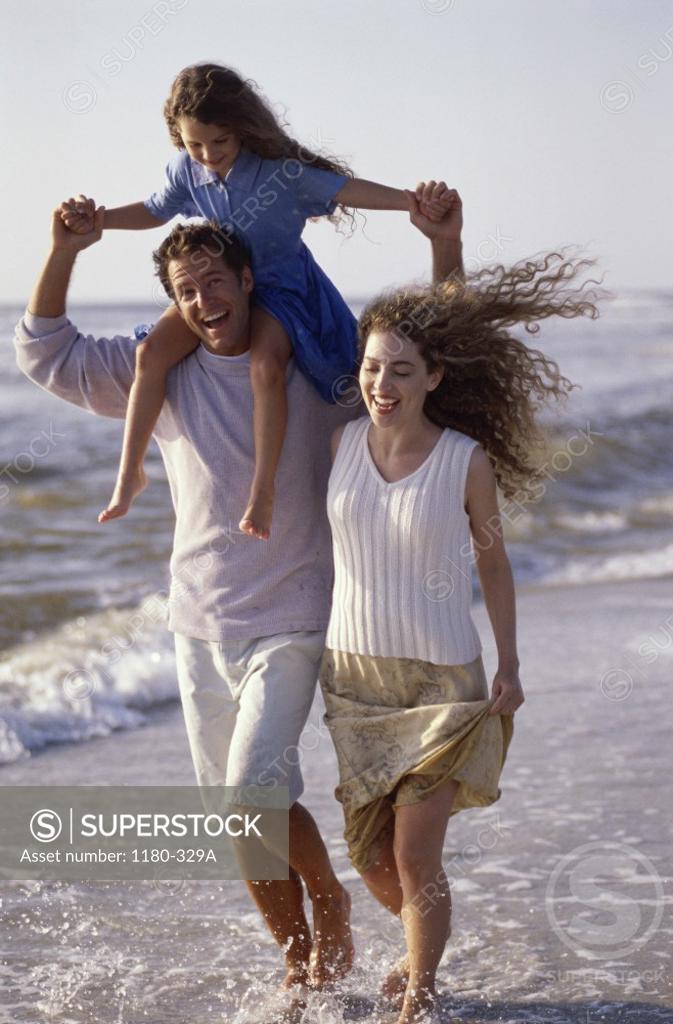 Stock Photo: 1180-329A Young couple on the beach with their daughter