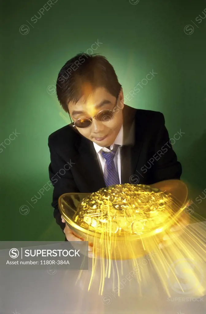 Businessman holding a pot of gold