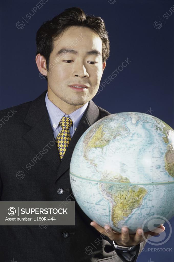 Stock Photo: 1180R-444 Businessman holding a globe