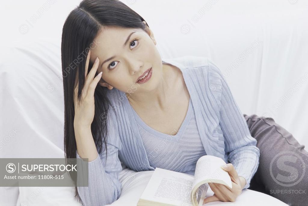 Stock Photo: 1180R-515 Portrait of a young woman holding a book