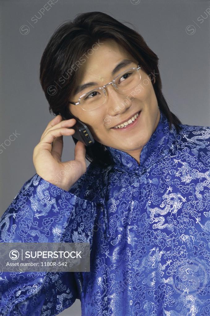 Stock Photo: 1180R-542 Young man talking on a mobile phone