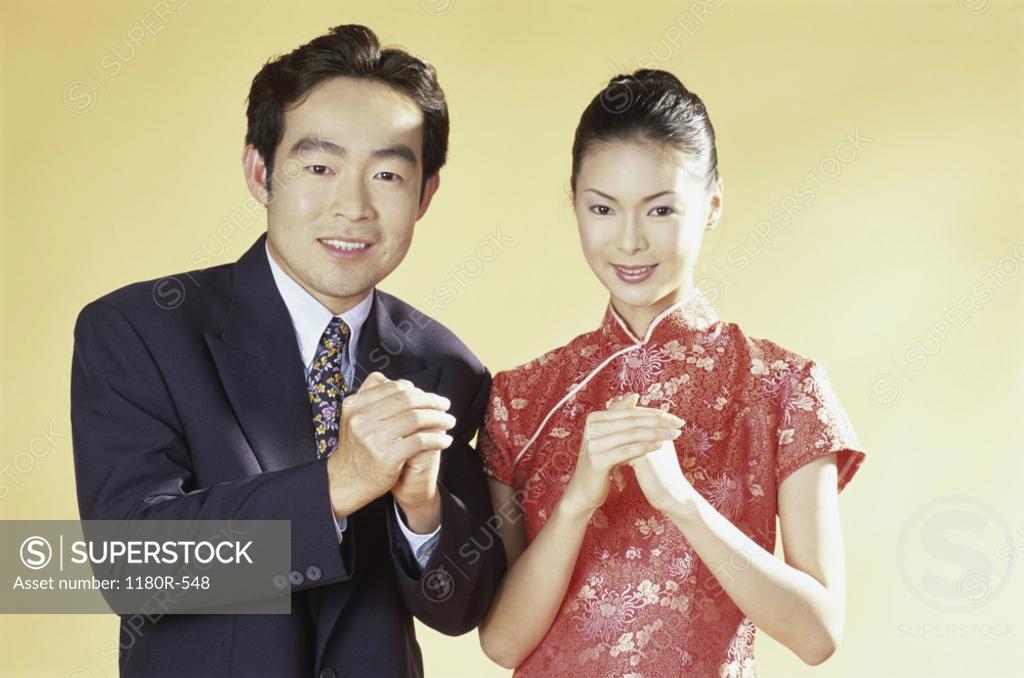 Stock Photo: 1180R-548 Portrait of a young couple with their hands together