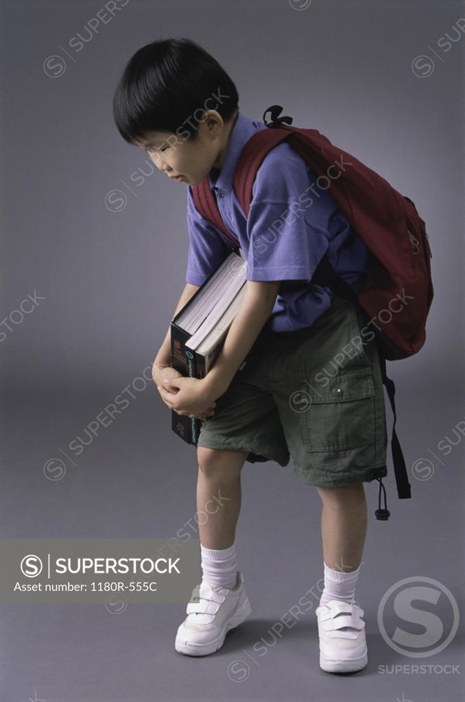 Stock Photo: 1180R-555C Boy carrying books and a backpack