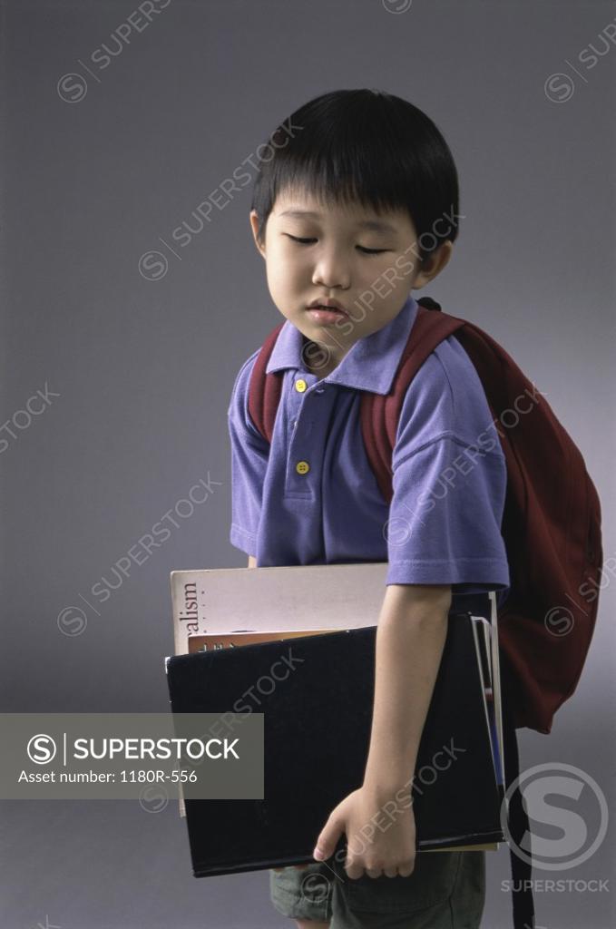 Stock Photo: 1180R-556 Portrait of a boy carrying book and a backpack