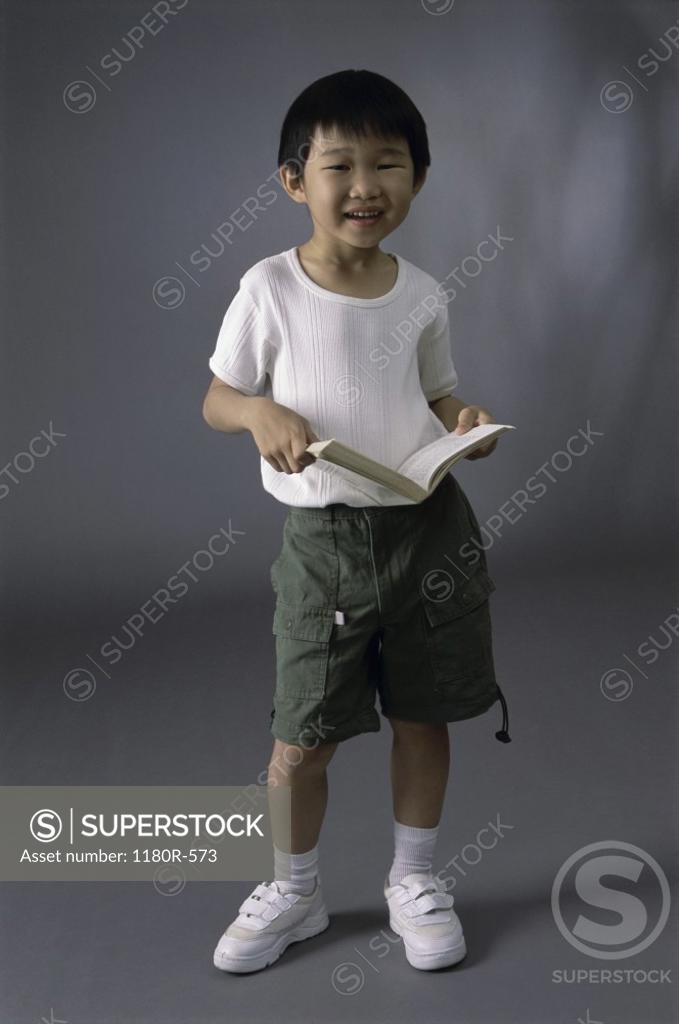Stock Photo: 1180R-573 Portrait of a boy holding a book
