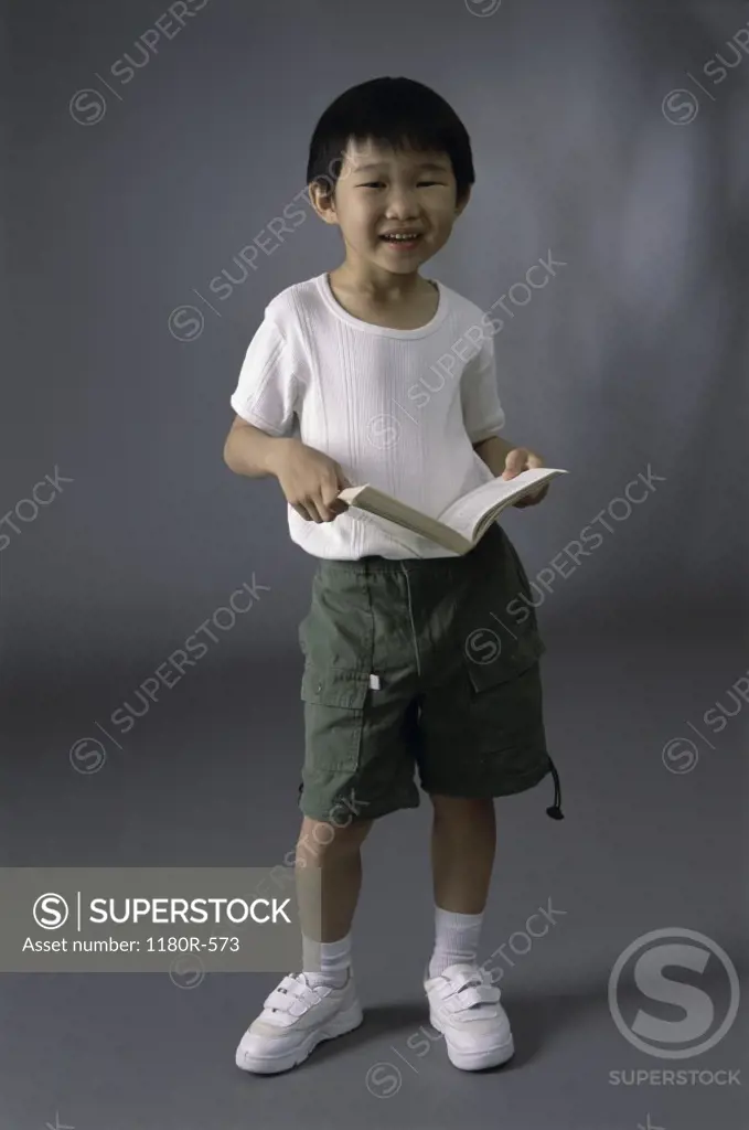 Portrait of a boy holding a book