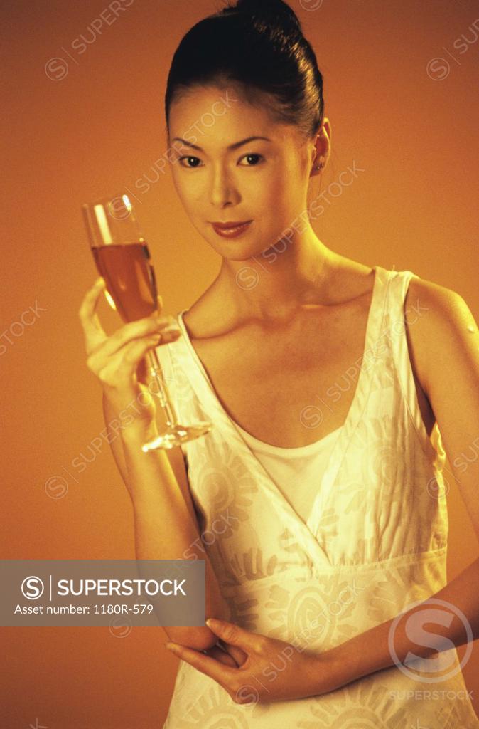 Stock Photo: 1180R-579 Portrait of a young woman holding a glass of champagne