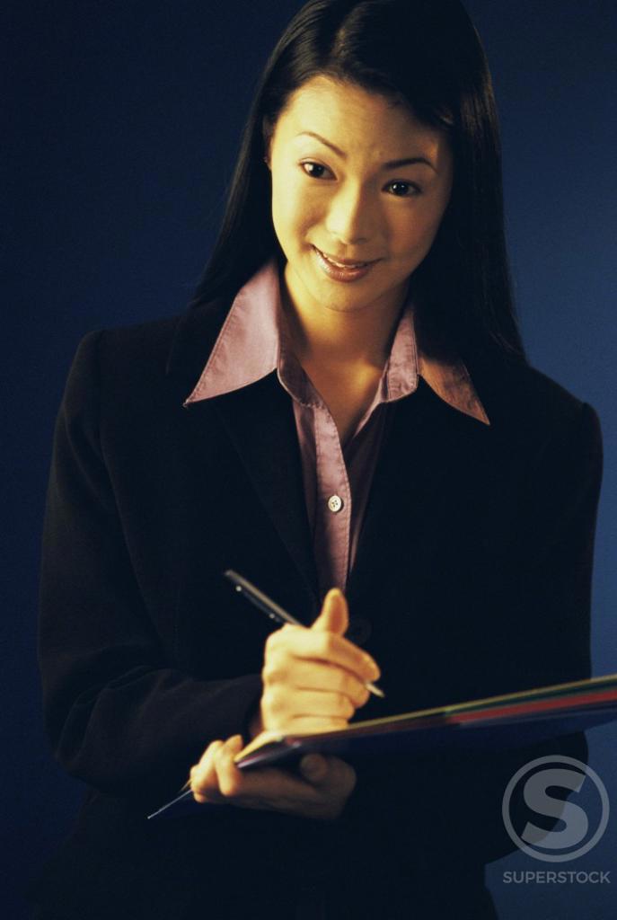 Portrait of a businesswoman writing on paper