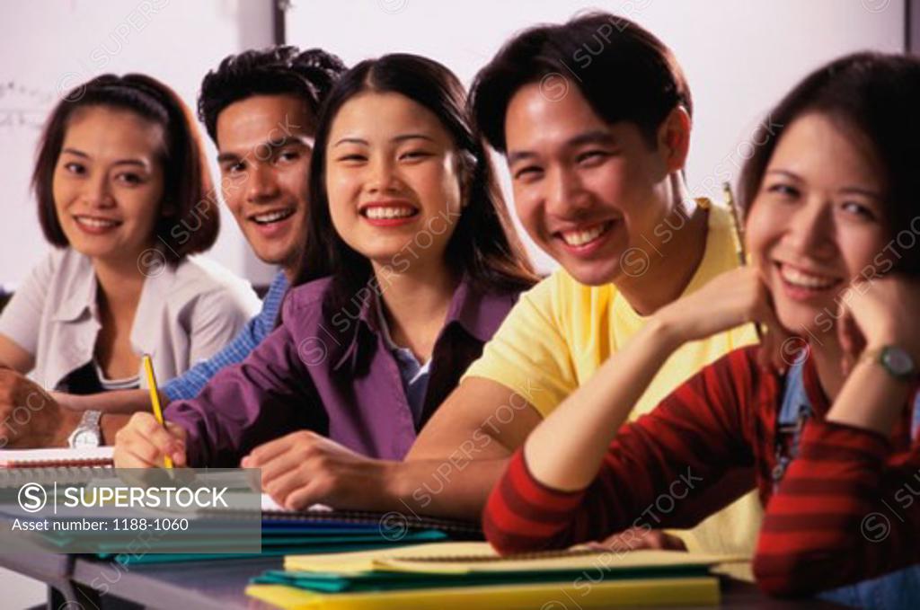 Stock Photo: 1188-1060 Portrait of five teenagers sitting in a row and smiling