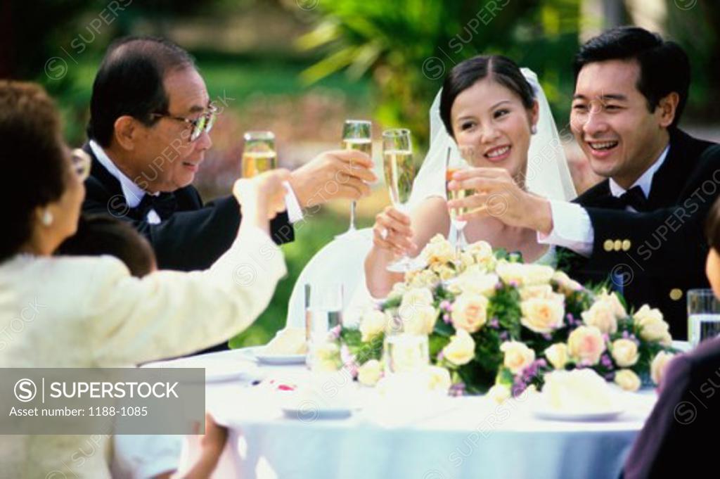Stock Photo: 1188-1085 Parents toasting with the newlywed couple