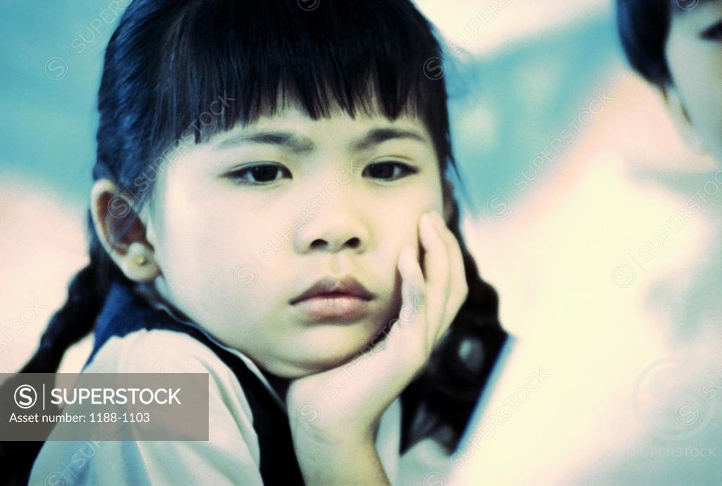 Stock Photo: 1188-1103 Close-up of a girl with her hand on her chin