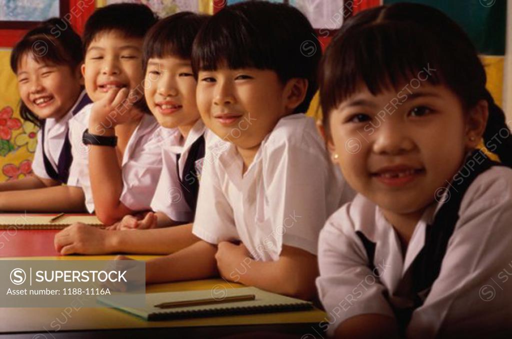 Stock Photo: 1188-1116A Group of children sitting in a row and smiling