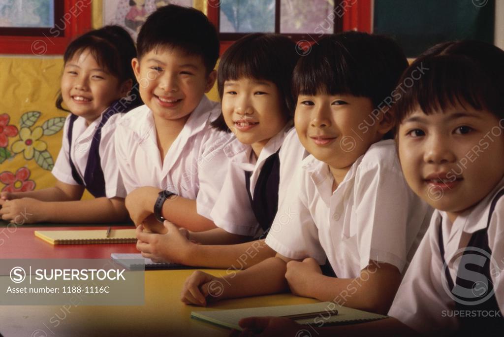 Stock Photo: 1188-1116C Group of children sitting in a row and smiling