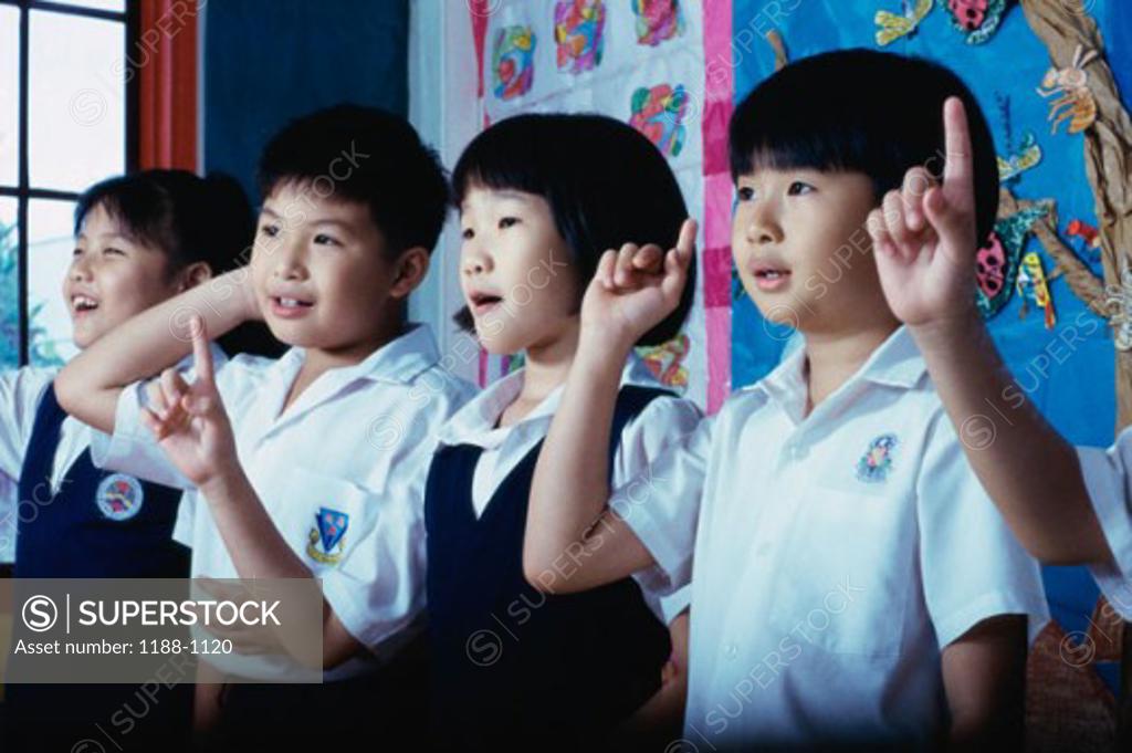Stock Photo: 1188-1120 Group of children raising their fingers in a row