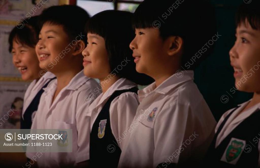 Stock Photo: 1188-1123 Group of children standing in a row and smiling