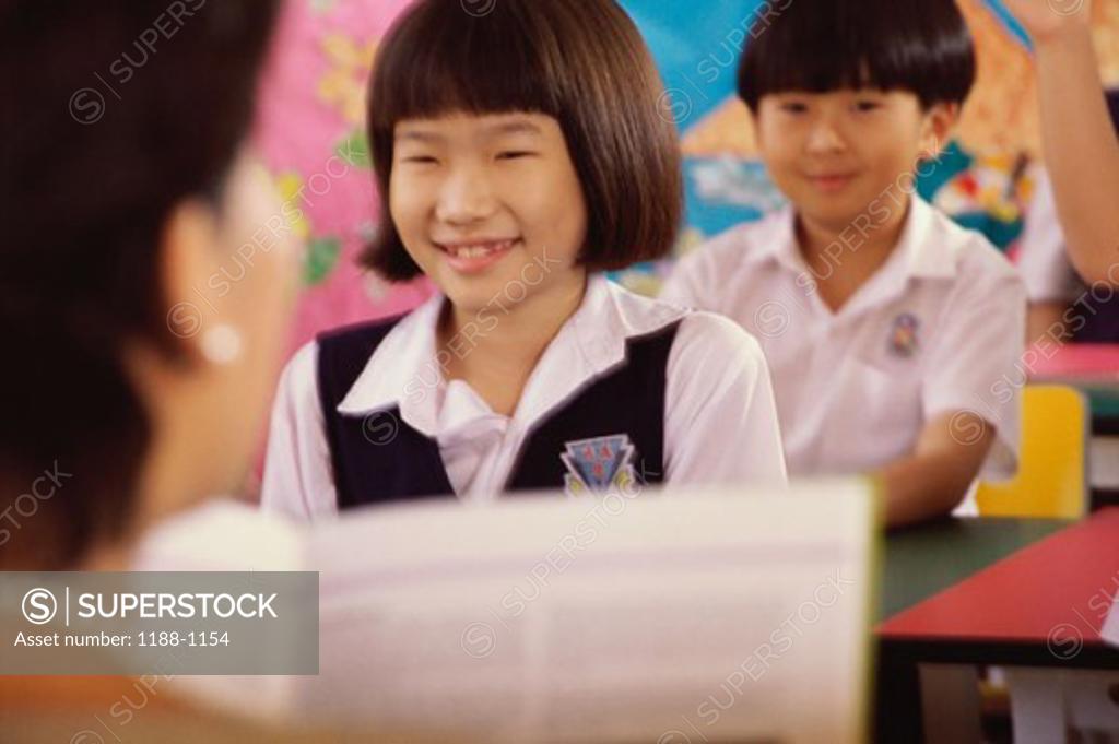 Stock Photo: 1188-1154 Girl smiling in a classroom