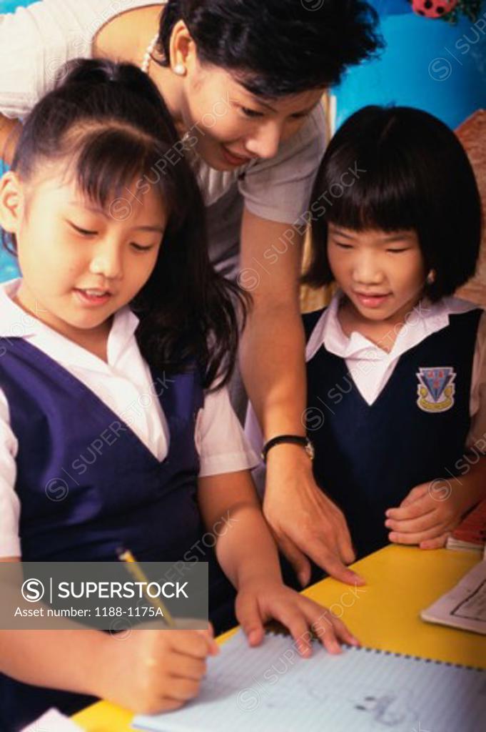 Stock Photo: 1188-1175A Teacher helping her students in a classroom
