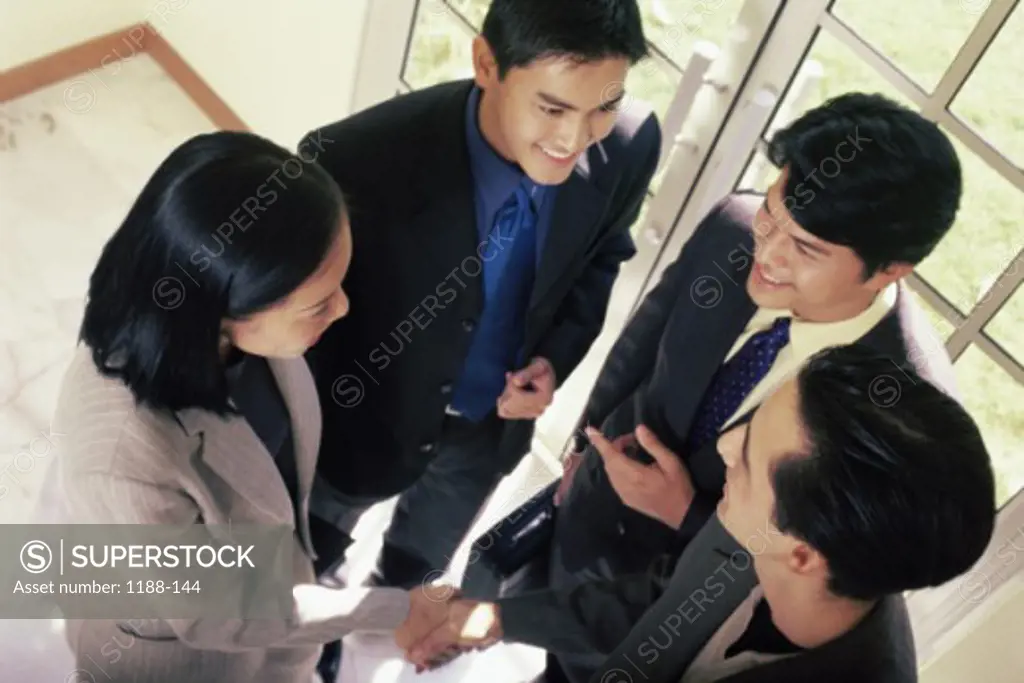 High angle view of business executives shaking hands