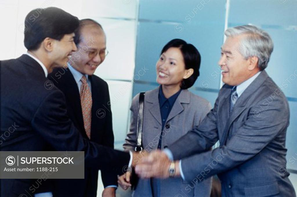 Stock Photo: 1188-215 Three businessmen and a businesswoman in a meeting