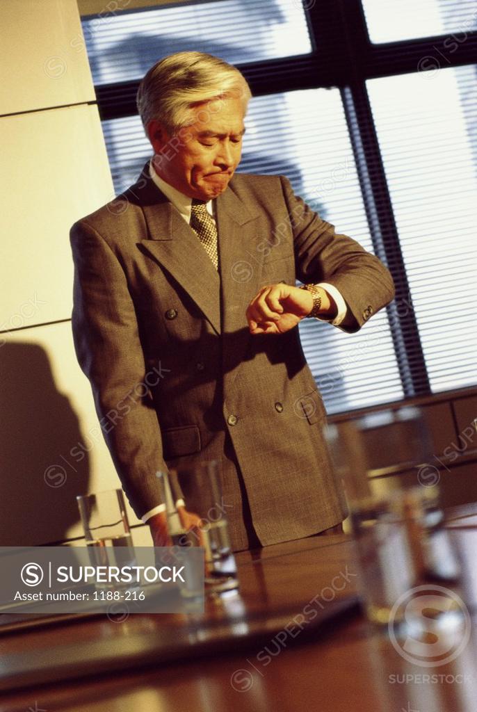 Stock Photo: 1188-216 Businessman looking at his wristwatch