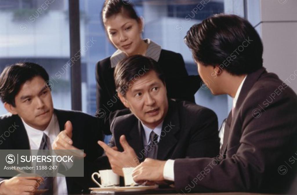 Stock Photo: 1188-247 Businesswoman with three businessmen in an office