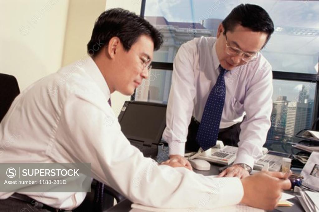 Stock Photo: 1188-281D Two businessmen working in an office