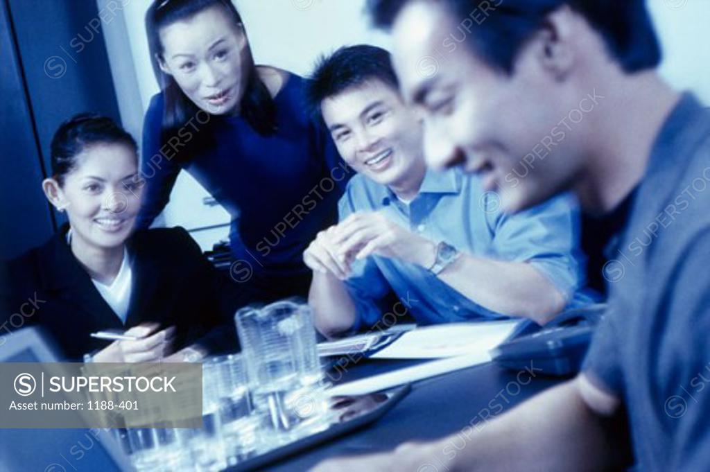 Stock Photo: 1188-401 Two businessmen and two businesswomen talking in a meeting