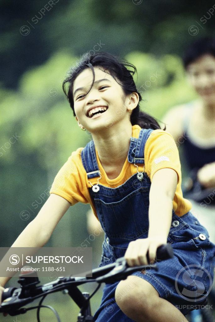 Stock Photo: 1188-651 Girl cycling and smiling