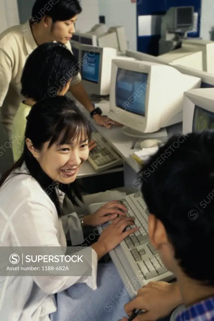 Group of teenagers in front of computers
