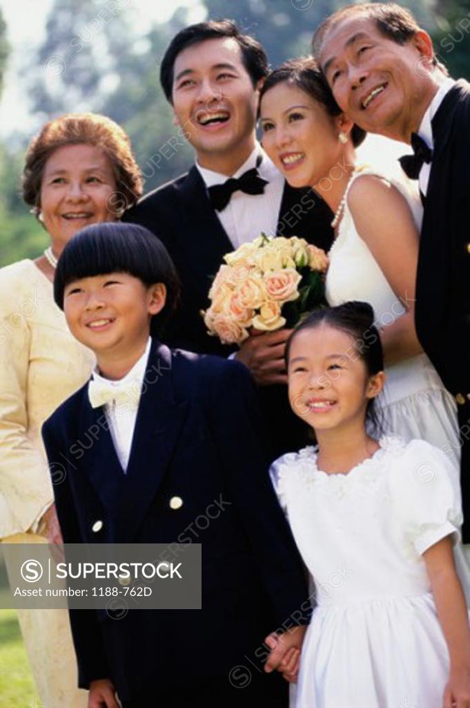 Stock Photo: 1188-762D Newlywed couple standing with their family and smiling