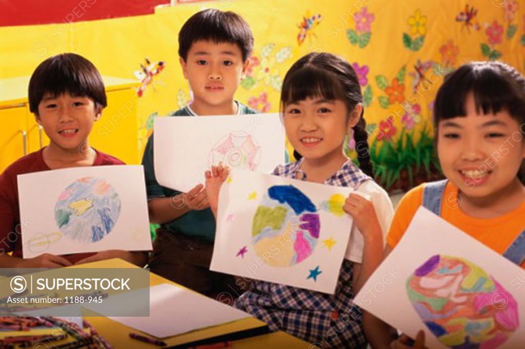 Stock Photo: 1188-945 Two girls and two boys showing their drawings and smiling
